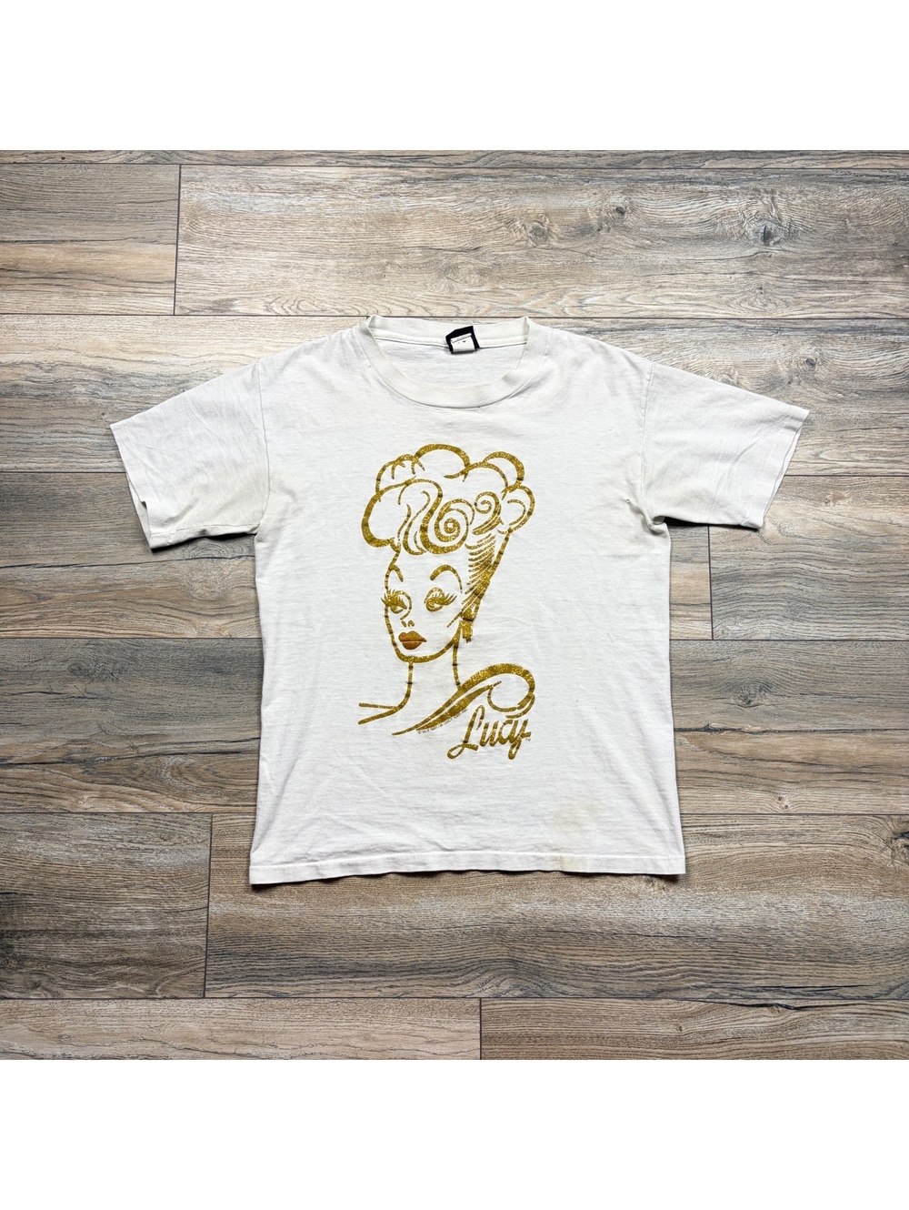 90s diamond dust Lucy gold T-shirt, featuring a gold lady some flaws size small